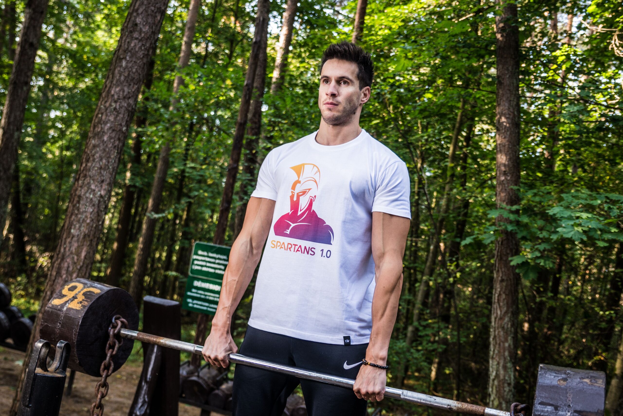 Beginner gym outfit featuring leggings, tank tops, fitness shirts, gym hoodies, fitness bras, mens tank tops, and activewear arranged inside a modern fitness studio.